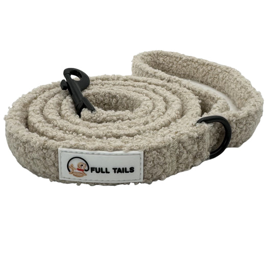 A beige teddy-textured dog leash with a padded handle and a metal clasp, featuring the brand label 'FULL TAILS' on a white label.