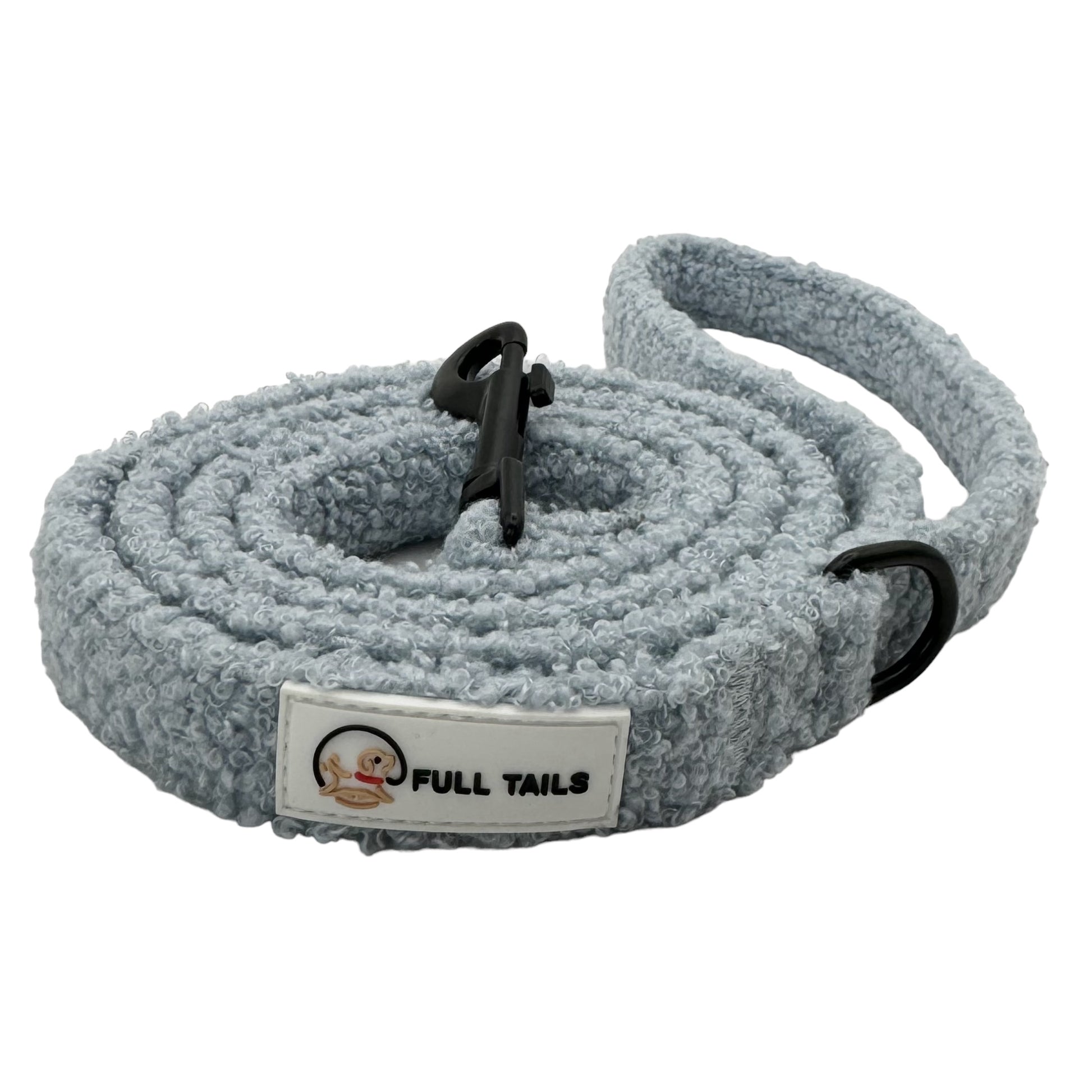 A gray teddy-textured dog leash with a padded handle and a metal clasp, featuring reflective stitching for safety.